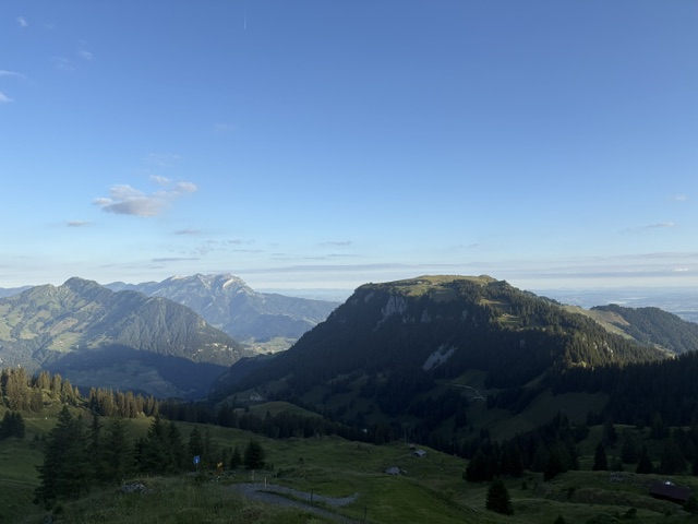 Early morning light over the Swiss Alps, where quiet mountain ridges stretch into the distance and nothing seems in a hurry.